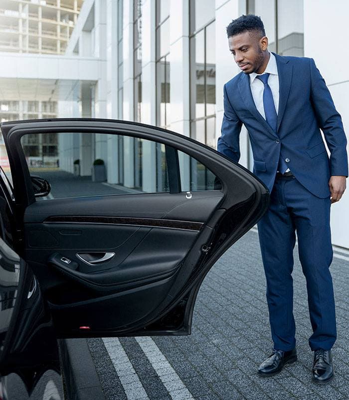 Luxury chauffeur greeting passenger